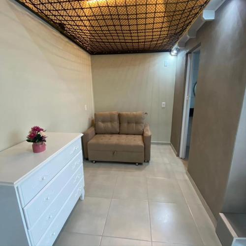 a living room with a couch in a room at Studio próximo hospital Unimed Tubarão in Tubarão