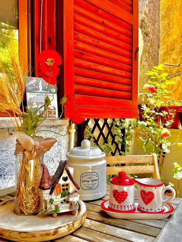 a table with a plate of food and a tea pot at LA GROTTA Guest House Subiaco in Subiaco