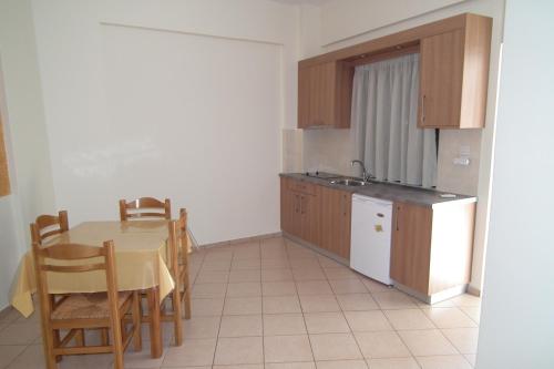 a kitchen with a table and a table and chairs at Gramvoussa Bay in Kissamos