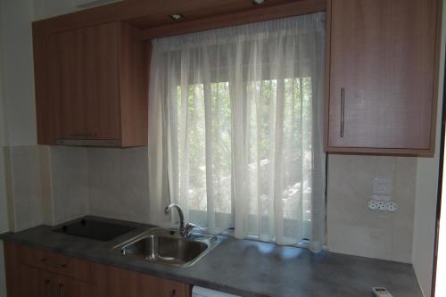 a kitchen with a sink and a window at Gramvoussa Bay in Kissamos