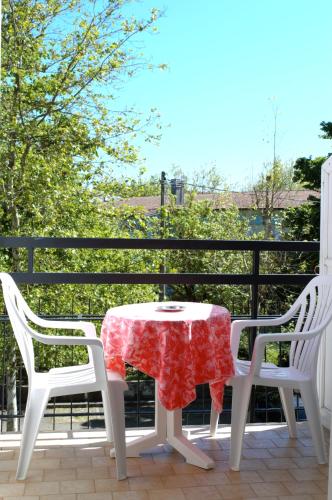 a table and two chairs on a patio at Hotel Lux in Cesenatico