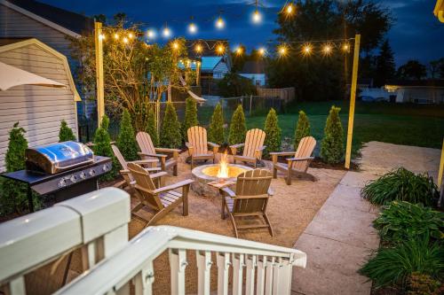 a backyard with a fire pit and chairs and lights at Cedar Point, Kalahari, Sports Force, Hot tub, Fire pit, EV, Pets, Beach, Fireplace, Park in Huron