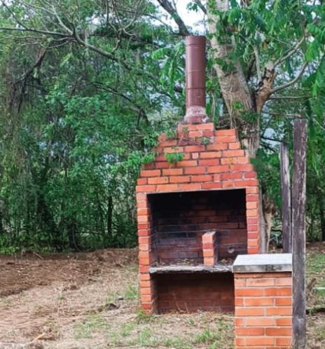 a brick oven sitting in the middle of a field at Finca La Macarena in Estación El Salto