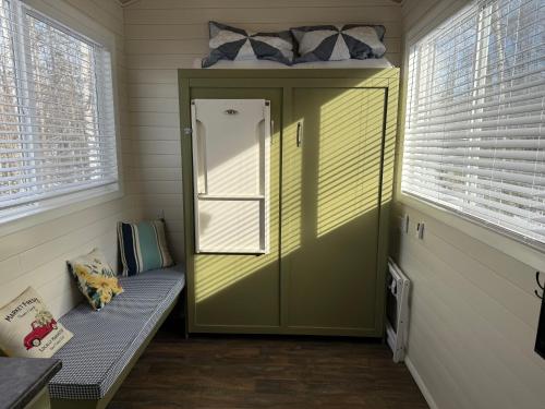 a small room with a door with a bench in it at Tiny Home at Bear Mountain -Only 25 Min from Anchorage, Great Central location-Cute & Comfortable in Anchorage