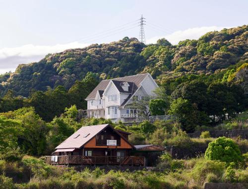 a house sitting on top of a hill at Pension Sora in Nachikatsuura