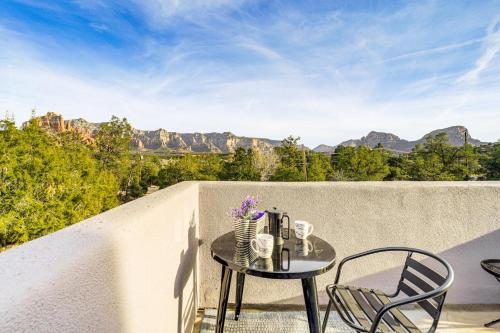 a table and chairs on a balcony with a view of mountains at Sedona Retreat Central & Cozy Red Rock Views in Sedona