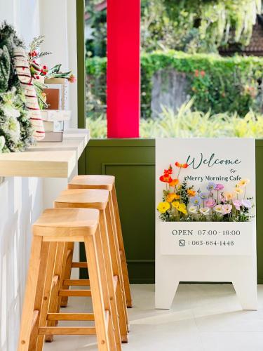 a sign for a flower shop with a stool at APA-TREE Boutique Hotel in Natai Beach