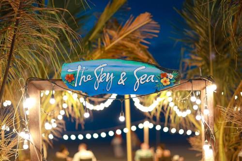 a sign that says the sky and sea with lights at The Sky & Sea Koh Larn in Ko Larn