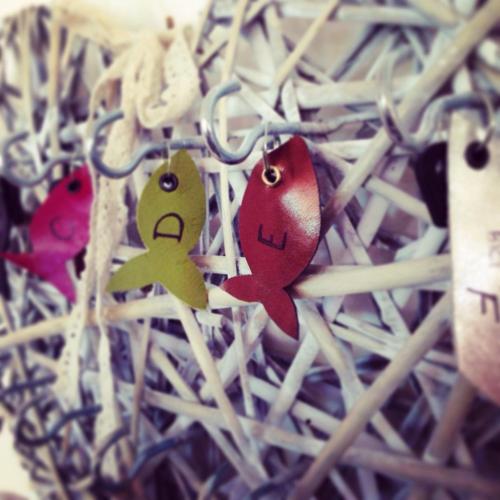a group of ornaments are hanging on a chain at Hotel Lux in Cesenatico