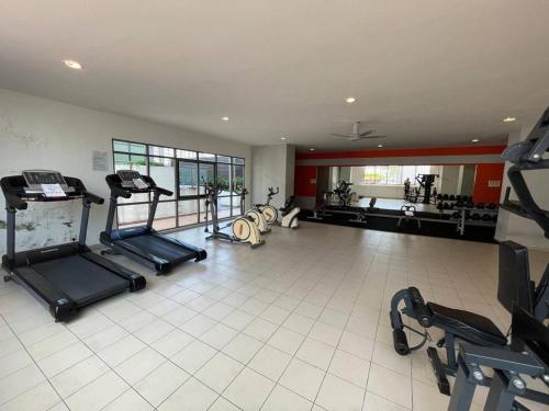 a large room with a gym with several exercise bikes at Evo Suites SOHO Bangi, homestay in Bandar Baru Bangi