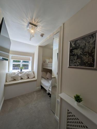 a small room with a window and a mirror at A historic Pub with a modern twist - The Greyhound in Bury Saint Edmunds