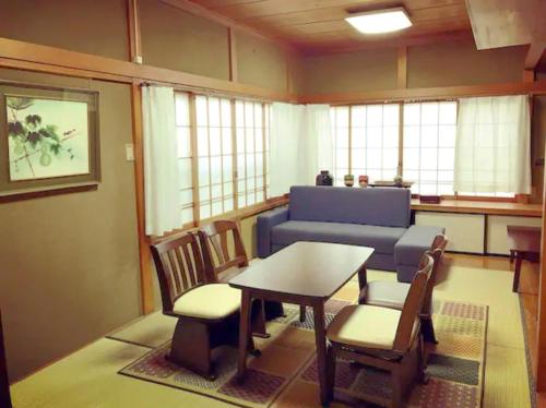 a living room with a table and chairs and a couch at Right nearby world heritage! 2BR Nikko Stay house in Nikko