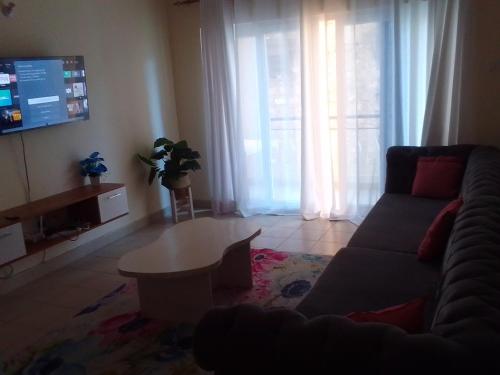 a living room with a couch and a table at Mtwapa Homes M Luxury Apartments in Mombasa