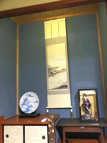 a room with two tables and a blue wall at Right nearby world heritage! 2BR Nikko Stay house in Nikko