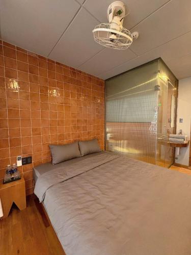 a bedroom with a large bed in a tiled wall at Local Charm Homestay in Thôn Trường Giang