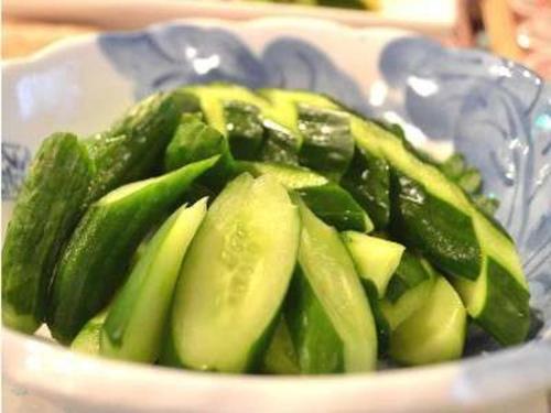 a bowl filled with green vegetables on a table at Hotel Green Selec in Sendai