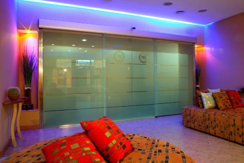 a living room with a couch and a glass wall at Hotel Futura Centro Congressi in Naples