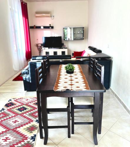 a dining room table with chairs and a table at Domus Komanesse - Guest Houses in Koman