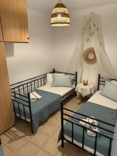 a bedroom with two beds and a tent at Aosa seaside home in Áyios Stéfanos