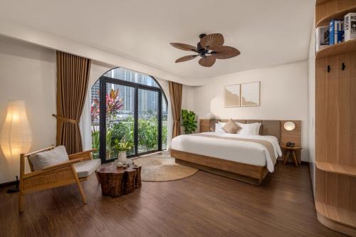a bedroom with a bed and a large window at Saha Casa Boutique Hotel Da Nang in Da Nang
