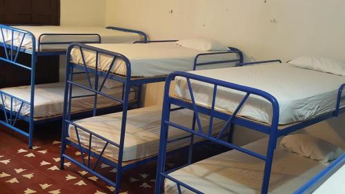 a group of four bunk beds in a room at Hostal El Jardin in León