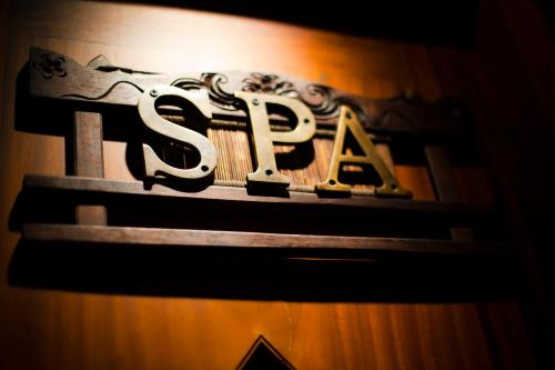 a sign on a wall with the word spa at Salana Boutique Hotel in Vientiane