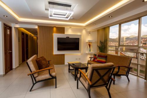 a living room with a couch and a table at Hotel Sky Mirador in Cusco