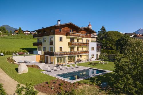 a large house with a swimming pool in front of it at Residence Schiestlhof in Naz-Sciaves