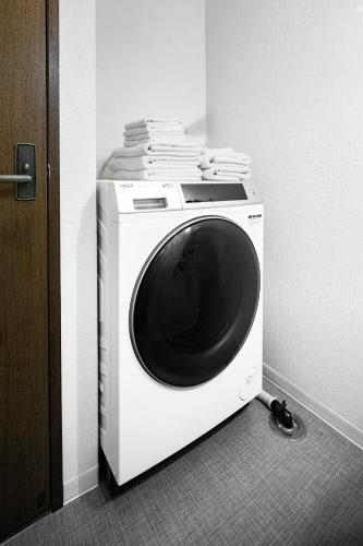 a washing machine with a round window on top of it at HITO 藤崎 Fujisaki in Fukuoka