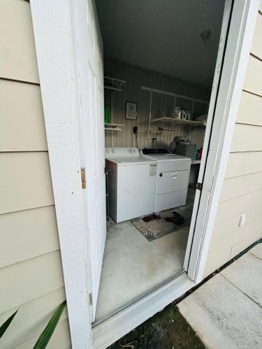 an open door to a kitchen with a sink at Trendy-attic at rice village in Houston