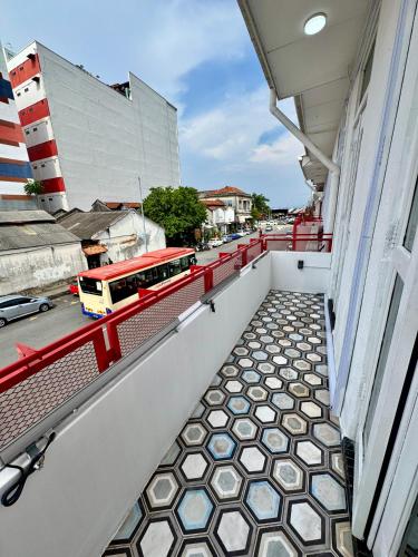 a balcony with a tiled floor and a bus on a street at The Harbour by Moonknight in George Town