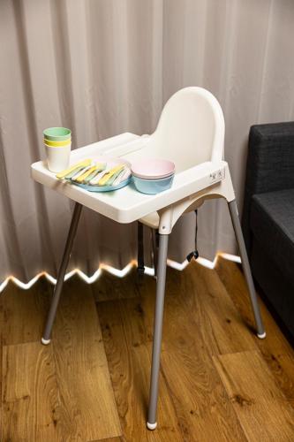 a white high chair with bowls and plates on it at HITO 藤崎 Fujisaki in Fukuoka