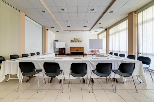 a conference room with a large table and chairs at Delfini Hotel in Patra