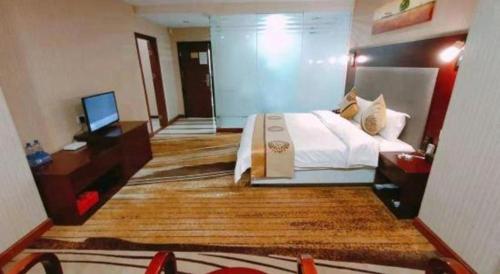 Postel nebo postele na pokoji v ubytování Wanxiang Hotel