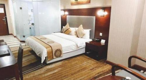 Postel nebo postele na pokoji v ubytování Wanxiang Hotel