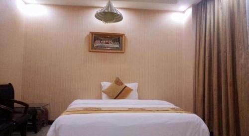 Postel nebo postele na pokoji v ubytování Wanxiang Hotel