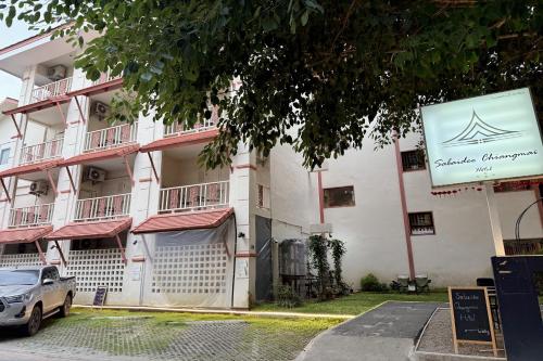 a building with a sign in front of it at Sabaidee Chiangmai Hotel in Chiang Mai