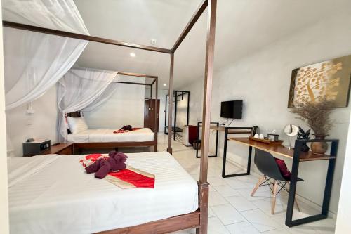 a bedroom with two beds and a desk in it at Sabaidee Chiangmai Hotel in Chiang Mai