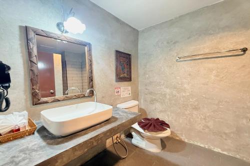 a bathroom with a sink and a toilet at Sabaidee Chiangmai Hotel in Chiang Mai
