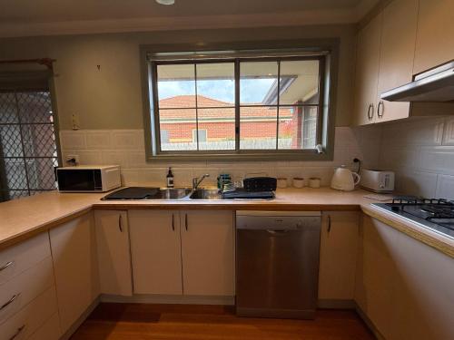 a kitchen with a sink and a window at Private Rooms in Bentleigh 1 min to Train Station, Cafes and close to Monash Uni in Melbourne