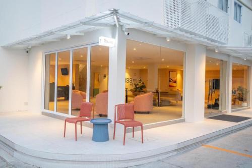 a building with two chairs and a table in it at 777Bliss Hometel in Nakhon Phanom