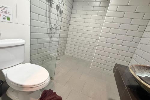 a bathroom with a toilet and a shower and a sink at Sabaidee Chiangmai Hotel in Chiang Mai