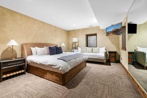 a bedroom with two beds and a tv in it at Wilder Woods in Michiana