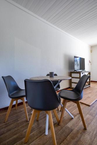 a dining room with two chairs and a table at Bed On Boucher in Durbanville