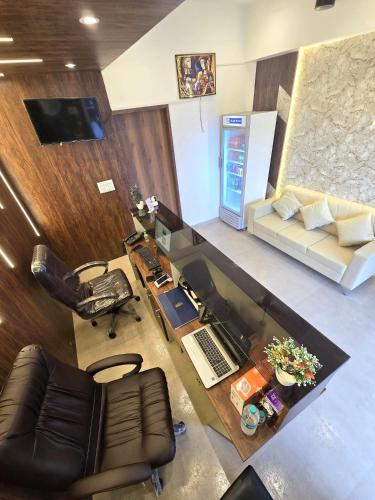 an overhead view of an office with a desk and a couch at Hotel The Ceremony in Kalyan