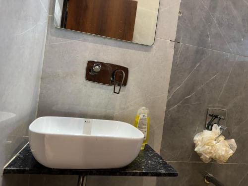 a white sink on a counter in a bathroom at Hotel The Ceremony in Kalyan