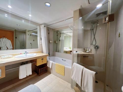 a bathroom with a shower and a sink and a tub at Holiday Inn Temple Of Heaven Beijing by IHG in Beijing