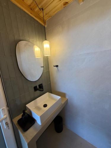 a bathroom with a white sink and a mirror at Villa Zoe (formerly Villa Eboros) in Ratzaklíon
