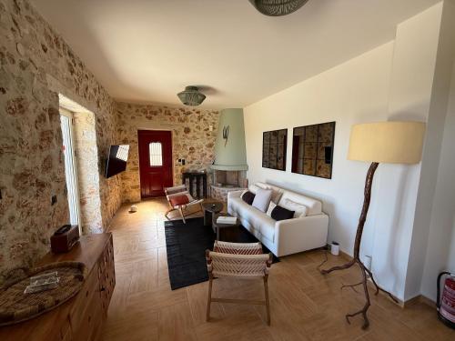 a living room with a couch and a table at Villa Zoe (formerly Villa Eboros) in Ratzaklíon