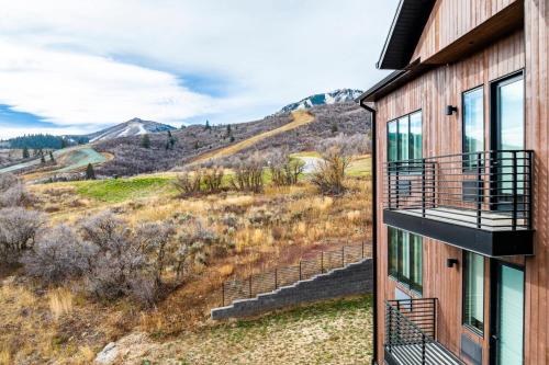 a house with a balcony with a view of a mountain at Pioche Village Park City in Park City